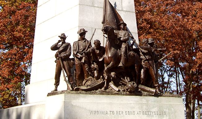 The Virginia Monument with its group of bronze figures, red autumn trees behind