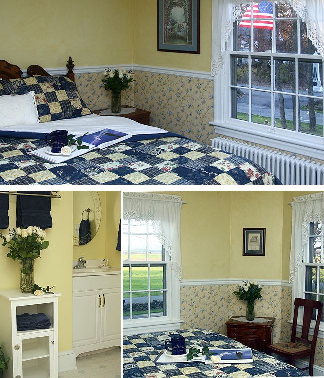 Iverson Room: blue and yellow patchwork bed with an American flag at the window, white vanity bathroom, window over green fields and a monument